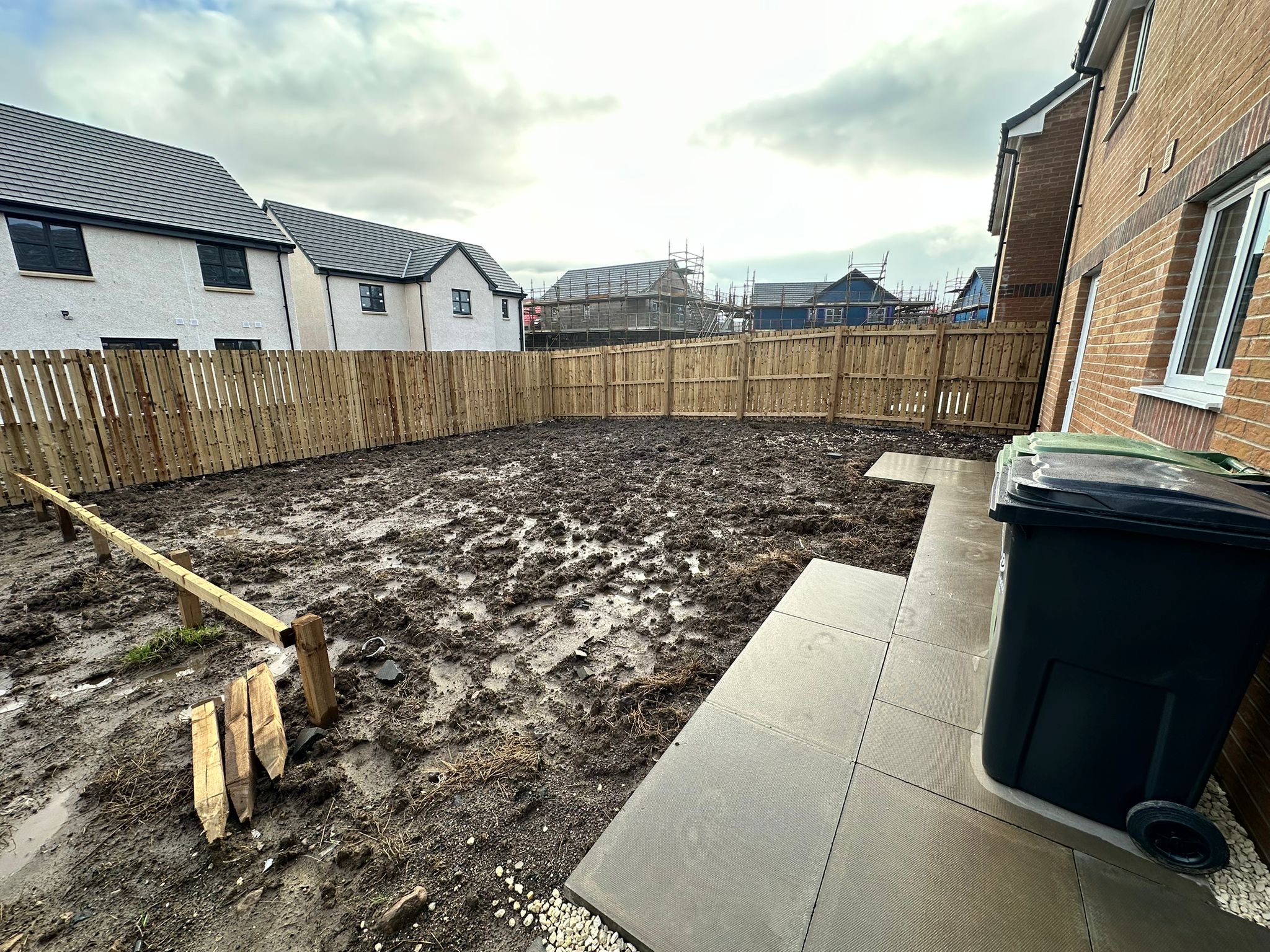 Unfinished muddy new build garden before landscaping